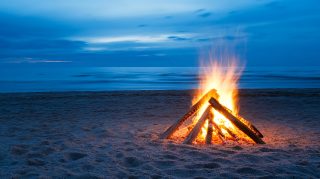 Free Desktop Background: Campfire on Sandy Beach